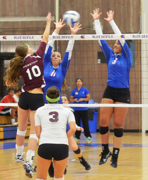 Sophomores Lily Thornberg (11) and Peyton Pender (3) attempt to block an attempted Hesston kill in KCKCC’s 3-0 win in the home opener Wednesday. (KCKCC photo by Rodney Christensen)