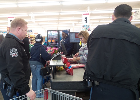 Happy Foods grocery store at 5420 Leavenworth Road today provided groceries for two families as a Christmas gift. The Leavenworth Road Association asked Community Policing officers to recommend some families for the gift. Officers Lightfoot and Parker accompanied the families and learned the art of sacking groceries. Happy Foods gives groceries to a family every Christmas season. (Photos by Lou Braswell)