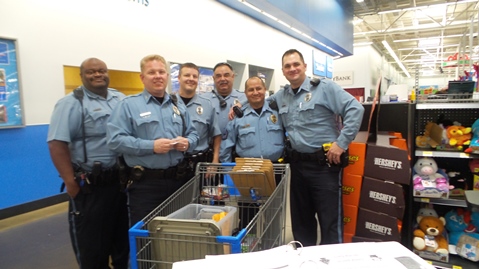 Community policing officers were ready for the shopping trip Thursday and Friday to Walmart in Kansas City, Kan. Many officers have been working on this event for years. The Kansas City, Kan., Police Department’s Community Policing Unit’s COPPS for Kids Christmas program was held on Thursday and Friday, and officers helped parents shop at Walmart at 10824 Parallel Parkway, Kansas City, Kan.  In the program families are assisted by donations from Kansas City, Kan., businesses and community members. Officers assist parents in shopping for more than 50 children, and then pay for the gifts that were chosen that day. The gifts then go to police headquarters where they are wrapped by volunteers. Then the gifts are given away at a Christmas party days later at City Hall, where the kids can meet Santa Claus. (Photo by Lou Braswell) 