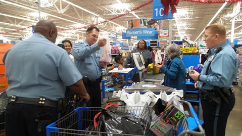 Many Kansas City, Kan., police officers have been working on the COPPS for Kids Christmas program for years. The shopping trip for this program was held on Thursday and Friday, and officers helped parents shop at Walmart at 10824 Parallel Parkway, Kansas City, Kan.  .  In the program families are assisted by donations from Kansas City, Kan., businesses and community members. Officers assist parents in shopping for more than 50 children, and then pay for the gifts that were chosen that day. The gifts then go to police headquarters where they are wrapped by volunteers. Then the gifts are given away at a Christmas party days later at City Hall, where the kids can meet Santa Claus. (Photo by Lou Braswell) 