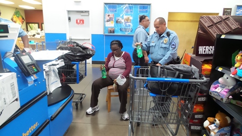 Shop ‘til you drop was a theme for some of the families who participated in the Kansas City, Kan., Police Department’s Community Policing Unit’s COPPS for Kids Christmas program. On Thursday and Friday, officers helped parents shop at Walmart at 10824 Parallel Parkway, Kansas City, Kan.  In the program families are assisted by donations from Kansas City, Kan., businesses and community members. Officers assist parents in shopping for more than 50 children, and then pay for the gifts that were chosen that day. The gifts then go to police headquarters where they are wrapped by volunteers. Then the gifts are given away at a Christmas party days later at City Hall, where the kids can meet Santa Claus. (Photo by Lou Braswell)