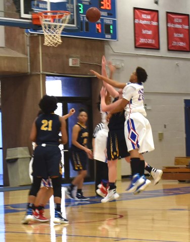 The Jayhawk Conference leader in blocked shots, KCKCC’s Cheyenne North knocks away a Shelby Dahl shot, one of her five blocks in a 64-60 loss to Johnson County Saturday. (KCKCC photo by Alan Hoskins)