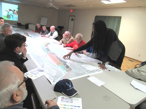 The moderator, Triveece Penelton, who is with a firm that is conducting the public meetings and study of the K-32 corridor, pointed to an area on the map at Tuesday night's meeting at the Grinter barn. (Staff photo by Mary Rupert)