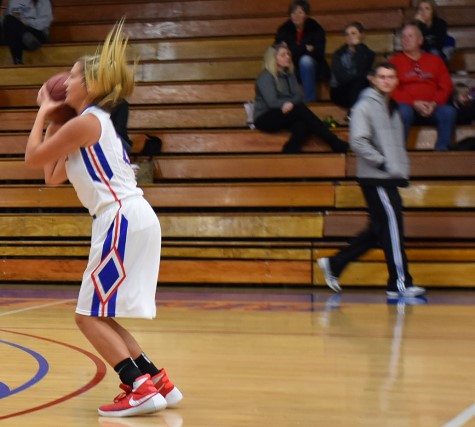 Just as her No. 1 fan, former KCKCC standout Clay Young now on the KU basketball team, walked in, Blue Devil sophomore Janay Jacobs put up this hair-raising shot in KCKCC’s 111-59 win over North Central Wednesday. (KCKCC photo by Alan Hoskins) 