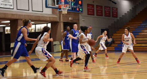 Sophomore Erin Anderson leads a fast break in Kansas City Kansas Community College’s 81-45 win over the Kansas Nuggets Thursday. She’s joined by teammates Sierra Roberts, left, Janay Jacobs (23) and Brooklyn Wagler (10). (KCKCC photo by Alan Hoskins)