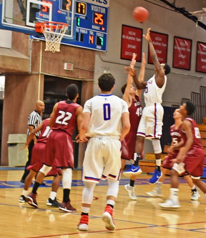 Kansas City Kansas Community College forward Armoni Shorter is nearly rim high as he releases a shot over a quintet of Wentworth Military Academy defenders in the Blue Devils’ 85-72 win Thursday. Maneuvering for a possible rebound is KCKCC’s Dehaven Talley (0). (KCKCC photo by Alan Hoskins)