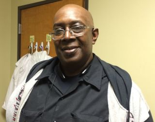 New Bethel Church guitarist Clarence Taylor obtained health insurance and a primary care physician with help from the church's health outreach coordinator.  (Photo by Alex Smith/Heartland Health Monitor)