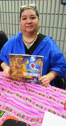 Xanath Caraza, an author and poet, held a copy of her book, “Ocelocihuatl," on Saturday at the Homegrown Reads program at the Kansas City, Kan., Public Library. (Photo by Mary Rupert)