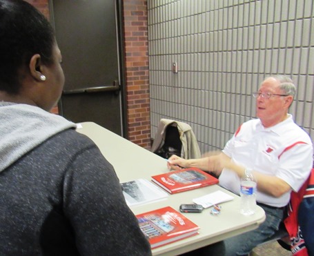 Retired Wyandotte High School teacher Craig Delich was surrounded by readers on Saturday at the Homegrown Reads program at the West Wyandotte Library. Delich's history of Wyandotte High School is now available. (Photo by Mary Rupert)