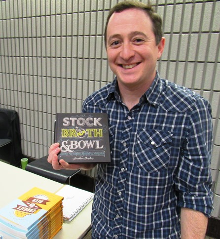 Jonathan Bender held his newest book, “Stock, Broth and Bowl," on Saturday at the Homegrown Reads program at the West Wyandotte Library. (Photo by Mary Rupert)