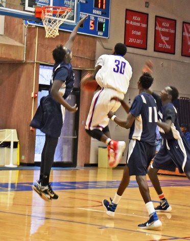 KCKCC guard Armonti Shorter (30) slashes between three Brown Mackie defenders in the Blue Devils’ 67-59 win Saturday. Not only did Shorter lead KCKCC in scoring with 14 points but he also sang the National Anthem prior to the game. (KCKCC photo by Alan Hoskins)