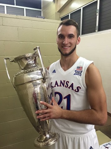 Now a member of the 12-time University of Kansas Big 12 championship basketball team, former KCKCC and Lansing standout Clay Young not only got a hold on the championship trophy but helped cut down the nets after the title-clinching win. (Photo from KCKCC)