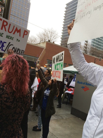 Protesters held signs outside the Trump rally Saturday in Kansas City, Mo. (Photo by Rebecca Tombaugh)