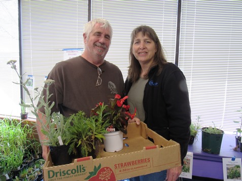 Marsha and Tim Kienzle, shopped for plants at the Master Gardeners Plant Sale Saturday, April 30, at the Extension Office, 1200 N. 79th St., Kansas City, Kan. The sale runs through 2 p.m. Saturday. They had tomato and pepper plants, herbs, hanging baskets, flowers and more available. Proceeds benefit the Master Gardeners’ activities in Wyandotte County. (Staff photo by Mary Rupert) 
