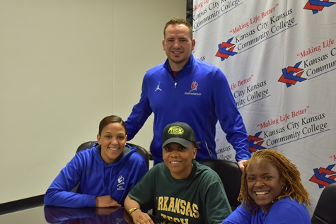 Surrounded by assistant coach Chamissa Anderson, left, head coach Joe McKinstry and assistant Dawn Owens, KCKCC All-American Cheyenne North signed a letter of intent last week to continue her basketball career at Arkansas Tech University. (KCKCC photo by Jason Broward)