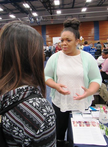 Man S. Cing, left, visited with Jennifer Lightsey of Aerotek about job openings at the Workplace Kansas City Job Fair April 27 at KCKCC. (Staff photo by Mary Rupert) 