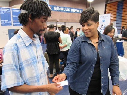 Le-Bray Lankford, left, a Kansas City Kansas Community College student, talked with Bridgette Allen, right, of Mosaic at the Workplace Kansas City Job Fair April 27 at the KCKCC field house. (Staff photo by Mary Rupert)