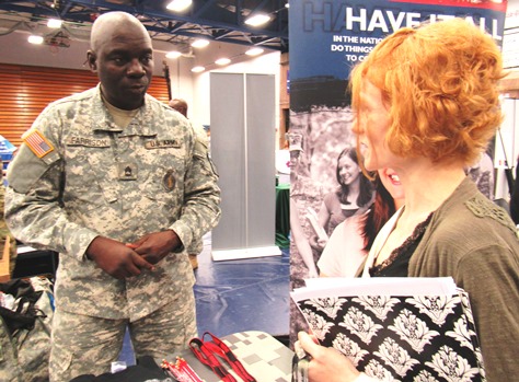 Vickie Juarez, right, of Kansas City, Kan., visited with Sgt. 1st Class Charles Farrison at the Kansas National Guard booth April 27 at the Workplace Kansas City Job Fair at KCKCC. (Staff photo by Mary Rupert)