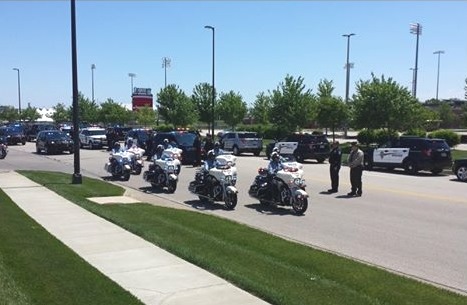 A large procession of motorcycles and law enforcement vehicles traveled from the funeral of Detective Brad Lancaster at Children's Mercy Park to a cemetery in Weston, Mo., today. (Photo by a community member)