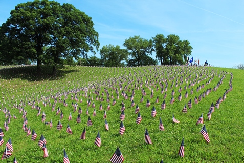 A memorial ceremony was held on Monday at Kansas City, Kan., City Park, 26th and Park Drive, to honor fallen veterans. The American Fallen Warrior Memorial Foundation held the ceremony and placed about 8,000 flags on the hills of City Park, where they are visible from I-70. Donations from Home Depot helped with the flags. The foundation is planning to build a monument at City Park to honor veterans who died in the Gulf War and the war on terror. For more information, visit http://afwmf.org/. (Photo by Steve Rupert)