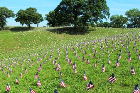 A memorial ceremony was held on Monday at Kansas City, Kan., City Park, 26th and Park Drive, to honor fallen veterans. The American Fallen Warrior Memorial Foundation held the ceremony and placed about 8,000 flags on the hills of City Park, where they are visible from I-70. Donations from Home Depot helped with the flags. The foundation is planning to build a monument at City Park to honor veterans who died in the Gulf War and the war on terror. For more information, visit http://afwmf.org/. (Photo by Steve Rupert)