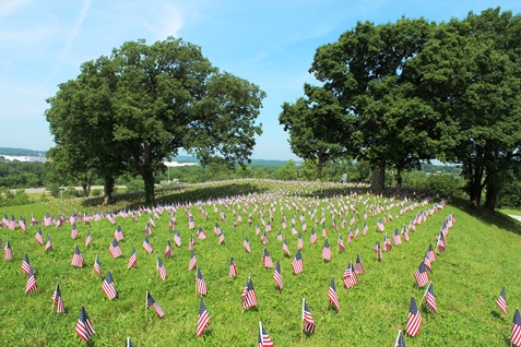 A memorial ceremony was held on Monday at Kansas City, Kan., City Park, 26th and Park Drive, to honor fallen veterans. The American Fallen Warrior Memorial Foundation held the ceremony and placed about 8,000 flags on the hills of City Park, where they are visible from I-70. Donations from Home Depot helped with the flags. The foundation is planning to build a monument at City Park to honor veterans who died in the Gulf War and the war on terror. For more information, visit http://afwmf.org/. (Photo by Steve Rupert)