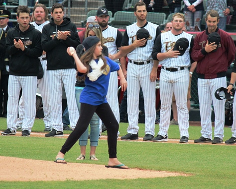 Detective Brad Lancaster's children threw out the first pitch at Thursday's T-Bones home opener at CommunityAmerica Ballpark, Kansas City, Kan. 