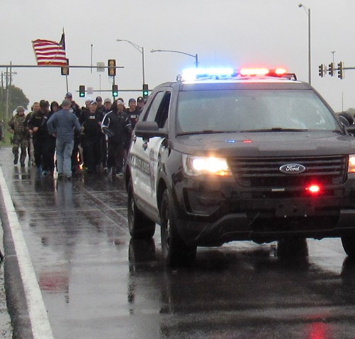 A cold, slow rain fell this morning as members of the Kansas City, Kan., Police Department ran a 1.4-mile stretch in full tactical gear on 118th in honor of slain Detective Brad Lancaster. Members of the Kansas City Kan., Police Department’s Special Operations Unit and other tactical units participated in the run, which started near where a vehicle was carjacked and traced a route to where he was killed, near the Hollywood Casino in Kansas City, Kan. The tactical team plans to do this run each year on May 9 in Detective Lancaster’s memory. (Staff photo) 