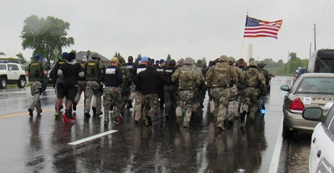 A cold, slow rain fell this morning as members of the Kansas City, Kan., Police Department ran a 1.4-mile stretch in full tactical gear on 118th in honor of slain Detective Brad Lancaster. Members of the Kansas City Kan., Police Department’s Special Operations Unit and other tactical units participated in the run, which started near where a vehicle was carjacked and traced a route to where he was killed, near the Hollywood Casino in Kansas City, Kan. The tactical team plans to do this run each year on May 9 in Detective Lancaster’s memory. (Staff photo) 