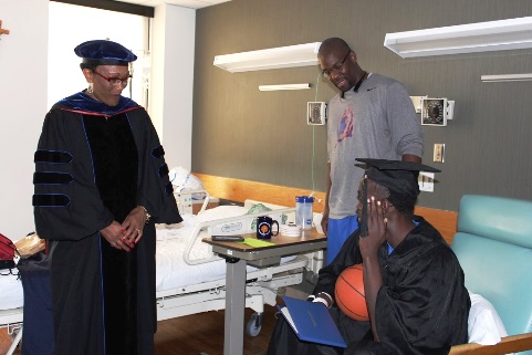 Armoni Shorter overcame illness and family tragedy to graduate recently from Kansas City Kansas Community College.  College President Doris Givens recently awarded his diploma at a hospital room. (KCKCC photo)