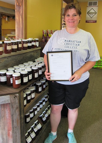 Stacey Sheahan showed her business license for Animal Crackers, plus some new items the store is carrying, Amish jams and jellies. (Staff photo)