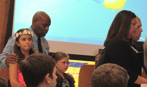 Kansas City, Kan., Police Deputy Chief Tyrone Garner, left, accompanied the late Detective Brad Lancaster’s children in the Police Awards ceremony Thursday, July 7, at the UG Commission meeting. (Staff photo)