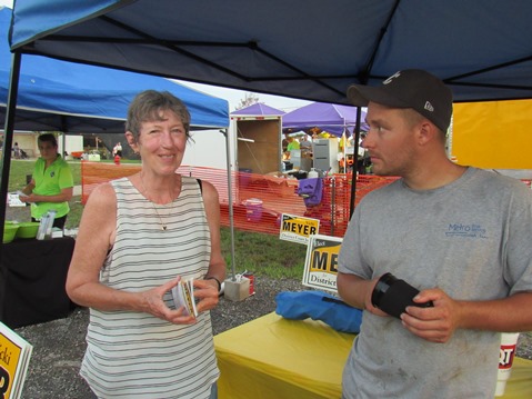 Vicki Meyer, a candidate for district court judge, was visiting with people at a booth Wednesday at the Wyandotte County Fair. (Staff photo by Mary Rupert)