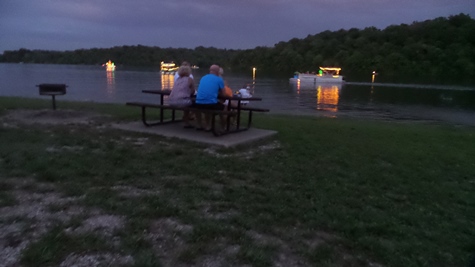 Pontoon boats lit up Wyandotte County Lake on Saturday night. (Photo by Lou Braswell)