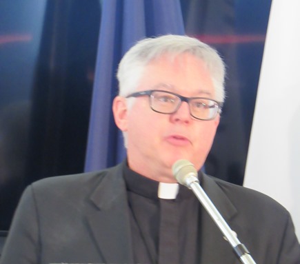 Monsignor Stuart Swetland, president of Donnelly College, offered a prayer today at City Hall. (Staff photo)