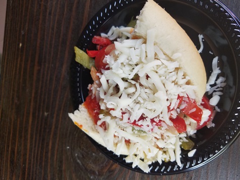 An Italian sausage sandwich is one of the featured items at the Renaissance Festival this year. (Photo by William Crum)