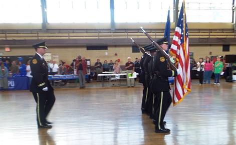 An honor guard presented the flag at the National Night Out Against Crime Aug. 2 at the Kansas National Guard Armory. (Photo by Lou Braswell)