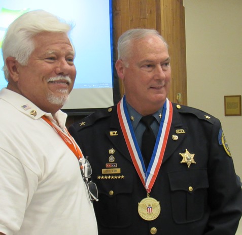 Wyandotte County Sheriff Don Ash, right, received national awards, the President’s Volunteer Service Award and the President’s Lifetime Achievement Award, on Thursday night for his volunteer work. The awards were presented by Stephen Barnhart, president, American Association for Higher Education and Accreditation of Grandview, Mo. (Staff photo by Mary Rupert)