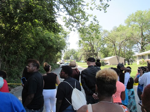 A crowd gathered across Parallel Parkway on 57th Street to watch the standoff. (Staff photo by Mary Rupert)