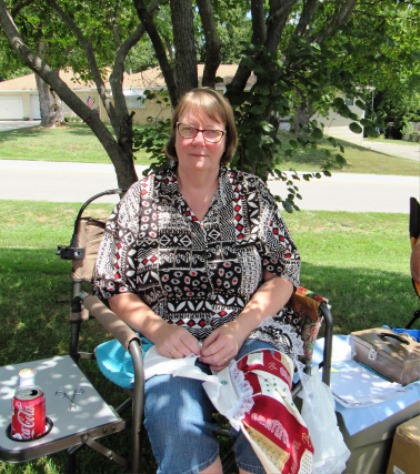 Kathy Bales Leavenworth, worked on an oven door dress towel while at the Grinter Summerfest on Saturday. The free Summerfest continues through 4 p.m. Saturday. (Staff photo)