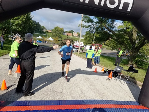 Skyler Schlageck took first place in the men’s division of the Dash KCK this morning. The 5K run sponsored by Donnelly College and the Downtown Shareholders started at the JFK Community Center, next to the Library in the Park event at Big Eleven Lake, 11th and State. (Photo by William Crum)