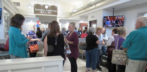 People chatted at the grand opening for Dr. Steven Pendleton's dental office today at 9000 State Ave. (Staff photo)