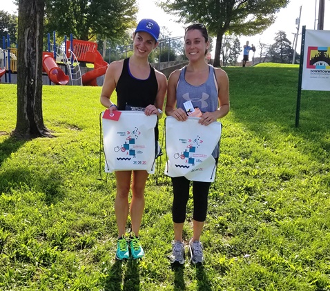 Becky Hayward took second place and Kristin Bennett took third place in the women’s division of the Dash KCK this morning. The 5K run sponsored by Donnelly College and the Downtown Shareholders started at the JFK Community Center, next to the Library in the Park event at Big Eleven Lake, 11th and State. (Photo by William Crum) 