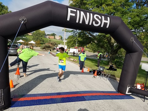 Joe Frost took second place in the men’s division of the Dash KCK this morning. The 5K run sponsored by Donnelly College and the Downtown Shareholders started at the JFK Community Center, next to the Library in the Park event at Big Eleven Lake, 11th and State. (Photo by William Crum)