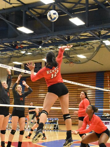 KCKCC sophomore Jessica Minear went high on a spike attempt while teammates Yvette Tamez and Alazia Stanley, right, looked on in the Blue Devils’ 3-0 loss to Cowley College Wednesday. (KCKCC photo by Brooklyn Bockover)