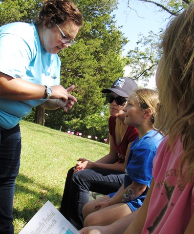 Hailey Moss, education specialist at the Schlagle Library, showed butterflies in a carrier to children attending the Lawson Roberts Butterfly Festival on Saturday at the Schlalge Library. (Staff photo by Mary Rupert)