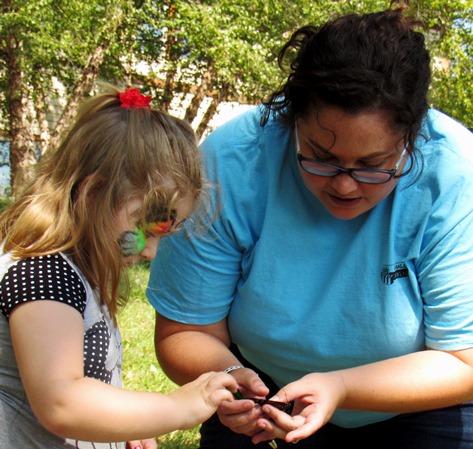 Hailey Moss, education specialist at the Schlagle Library, showed butterflies in a carrier to children attending the Lawson Roberts Butterfly Festival on Saturday at the Schlalge Library. (Staff photo by Mary Rupert)