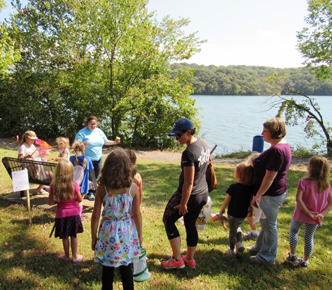 Children and adults played the monarch migration challenge game on the lawn at the Schlagle Library at Wyandotte County Lake Park on Saturday. (Staff photo by Mary Rupert)