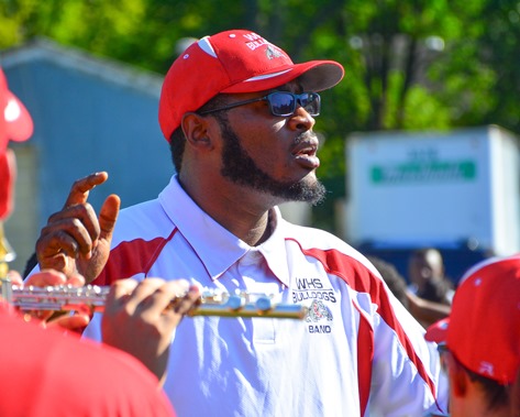 Deandre Tatum, assistant director of the Wyandotte High School Marching Band, led the band in a song during a Battle of the Bands with Washington High School following the Leavenworth Road Parade. (Photo by Brian Turrel)