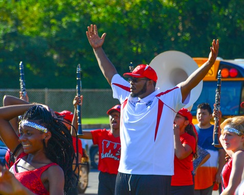 Deandre Tatum, assistant director of the Wyandotte High School Marching Band, raised his arms in celebration at the conclusion of a Battle of the Bands with Washington High School following the Leavenworth Road Parade. (Photo by Brian Turrel)